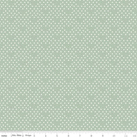 Fabric with small white polka dots on a light green background