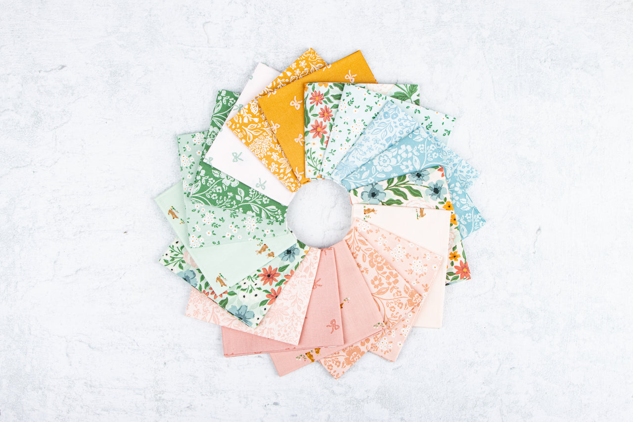 Collection of colorful fabric swatches arranged in a circular pattern on a white background