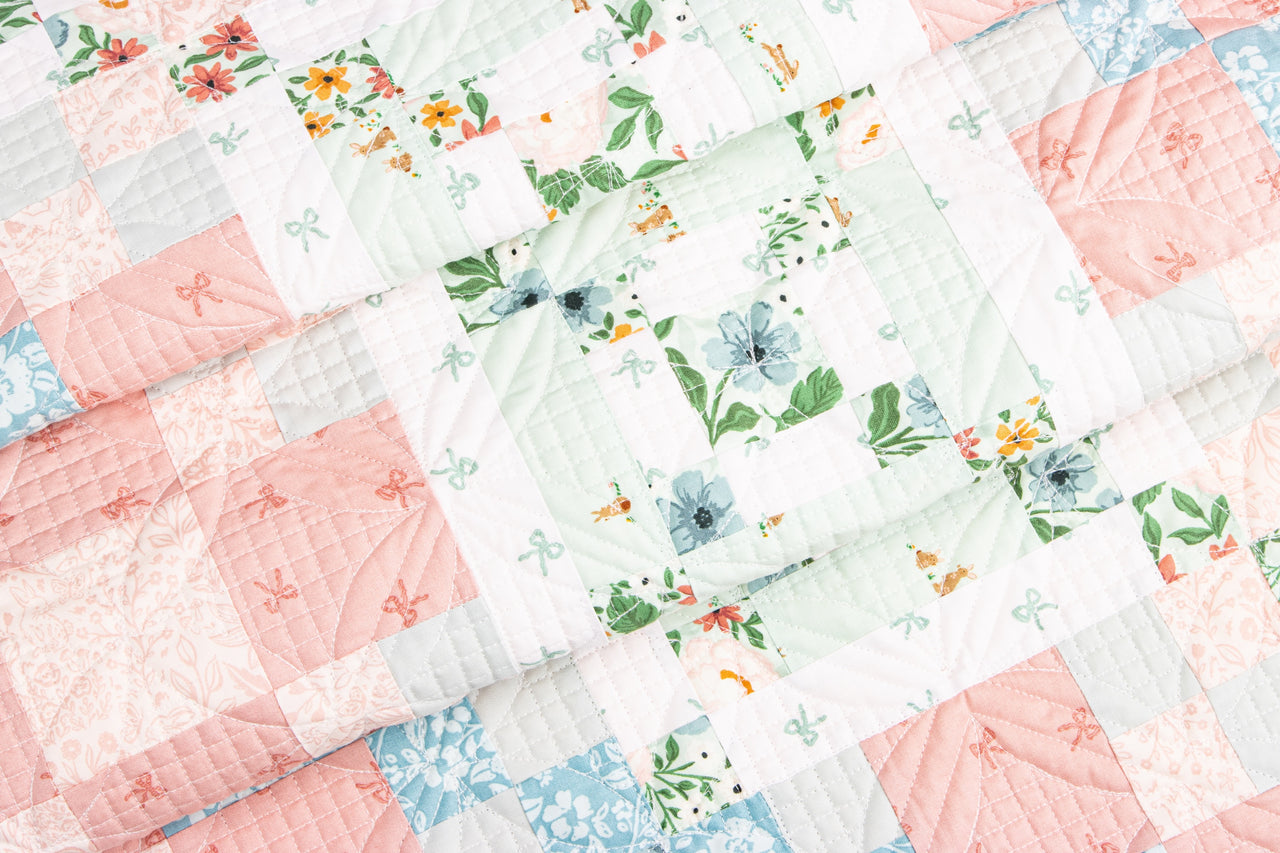 Floral quilt with pink, green, and blue colors