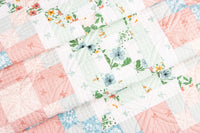 Floral quilt with pink, green, and blue colors