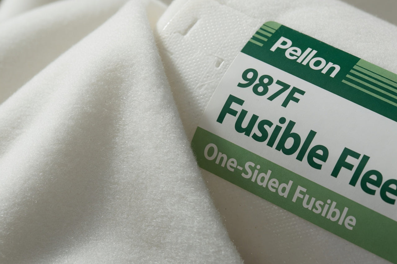 Pellon 987F Fusible Fleece label on a piece of white fabric